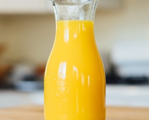 yellow liquid in clear glass bottle