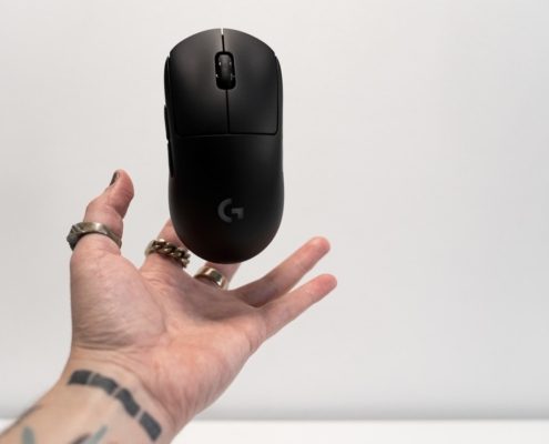 person holding black hp cordless computer mouse