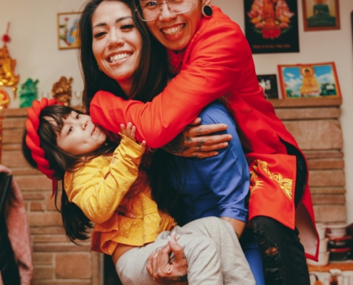 a man and a woman holding a child in their arms