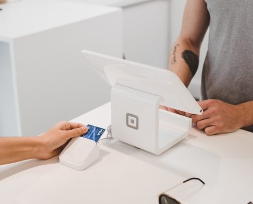 person using white tablet computer on table