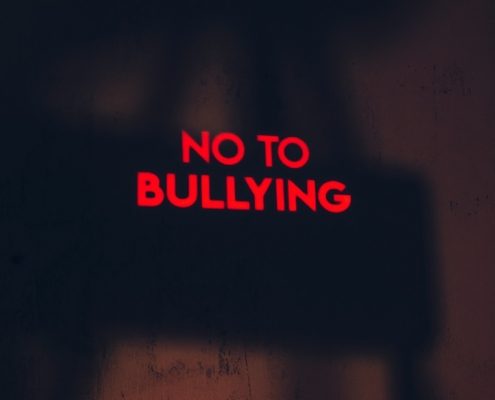 a red sign that says no to bullying